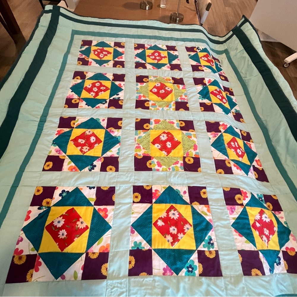 Vibrant Patchwork Quilt with Floral Accent. Pat, cut,sewn&quilted MAD-G creation